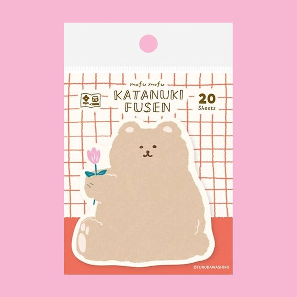 A package of cute bear-shaped sticky notes on a solid pink background. The notes feature a beige cartoon bear holding a small pink flower, with the text 'mofu mofu KATANUKI FUSEN 20 Sheets' on the packaging.