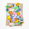 A Back picture of the terrain card print. Multicolour abstract shapes on a grid background.