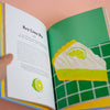 An illustration of a cake in a book on a peach background