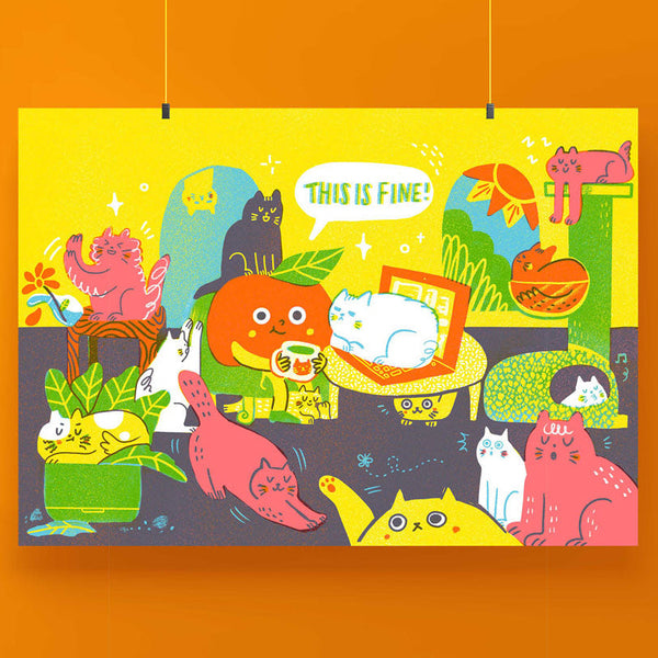 A colourful cartoon art print featuring multiple playful cats in a cat-height scene with a speech bubble that says 'THIS IS FINE!', hanging against a solid orange background.