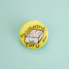 A round yellow pinback button featuring a hand-drawn illustration of a smiling tofu block with the words 'THOUGHTFUL TOFU' in black lettering, set against a solid light blue background.