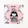 Pin with a design of a girl and cats on a pink background with 'shuh. pins' text.