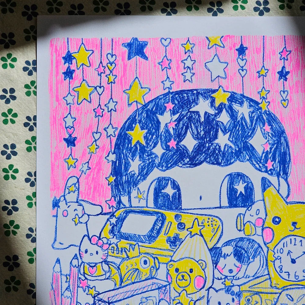 A colourful hand-drawn illustration on a white sheet of paper, featuring cartoon characters, stars, and a pink background, placed on a patterned surface.