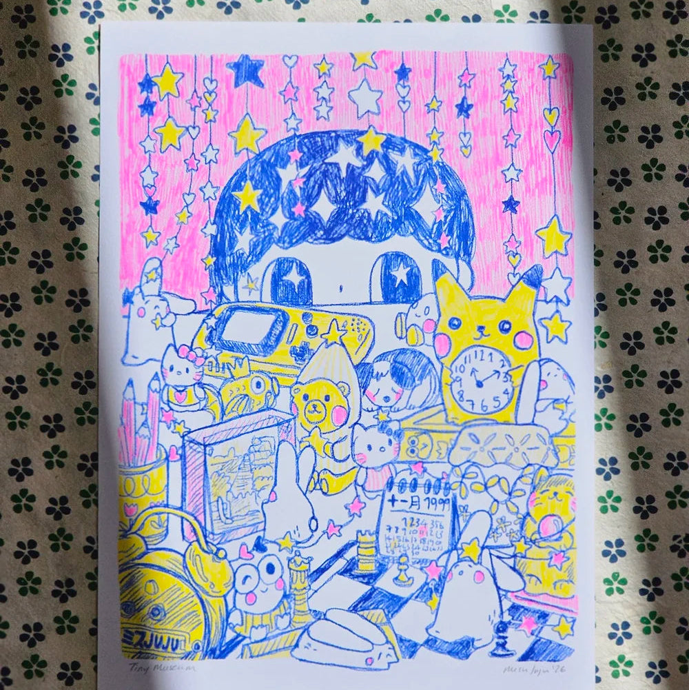 A colourful hand-drawn art print featuring cute cartoon characters, animals, and objects under a starry pink sky, placed on a patterned fabric background.