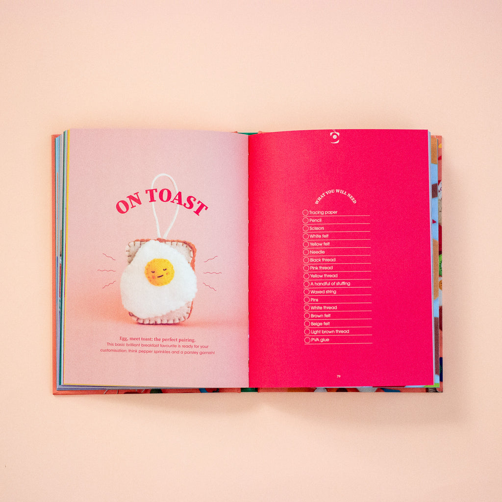 Open book with a pink page featuring an egg plush toy and text on a peach background
