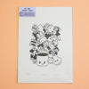A printed art piece with a black line drawing of a pile of cute cartoon characters, photographed against a peach-coloured background. A purple label in the top-left corner reads 'BY IMI PRINT SHOP'.