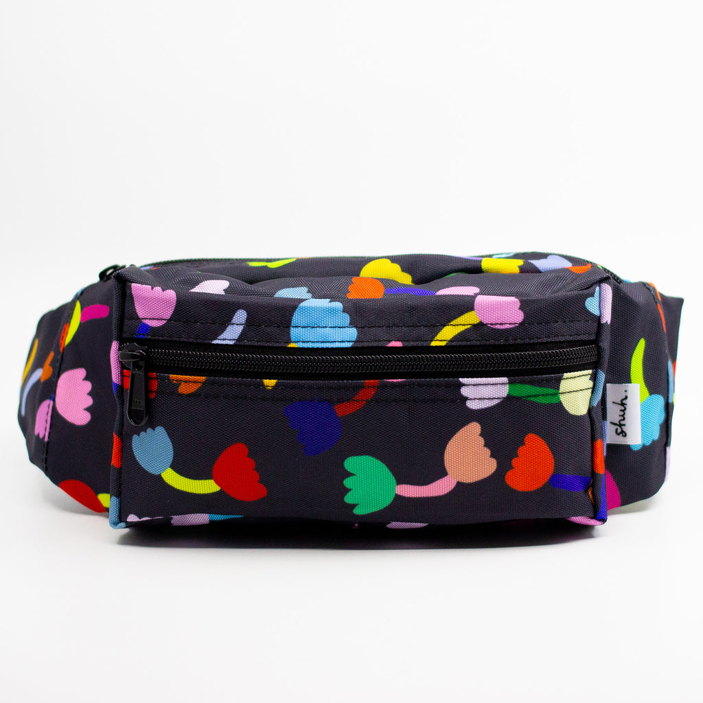 Front view of the tulip bumbag. The Tulip print is a playful and colourful series of multicoloured tulip motifs on a black background.