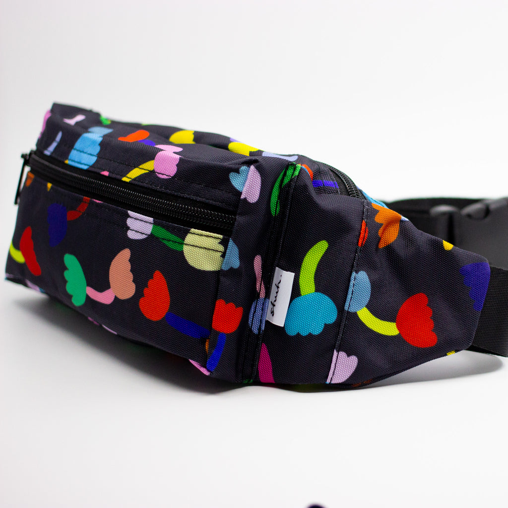 Side view of the tulip bumbag. The Tulip print is a playful and colourful series of multicoloured tulip motifs on a black background.