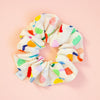 Colourful floral scrunchie on a peach background