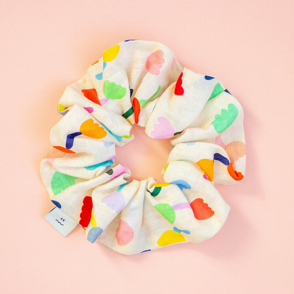 Colourful floral scrunchie on a peach background