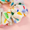 Colourful floral scrunchie on a peach background
