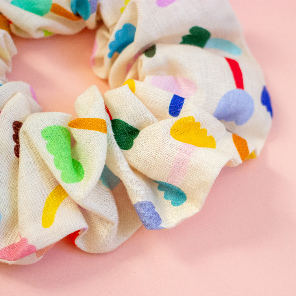 Colourful floral scrunchie on a peach background