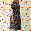 A front view of the Tulip linen dress. Multicoloured tulips on a black background.