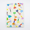 Back view of the tulip notebook. Cover has multicoloured tulip motif on cream background. Also shows inside with blank white pages. 