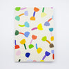 Front view of the tulip notebook. Cover has multicoloured tulip motif on cream background. 