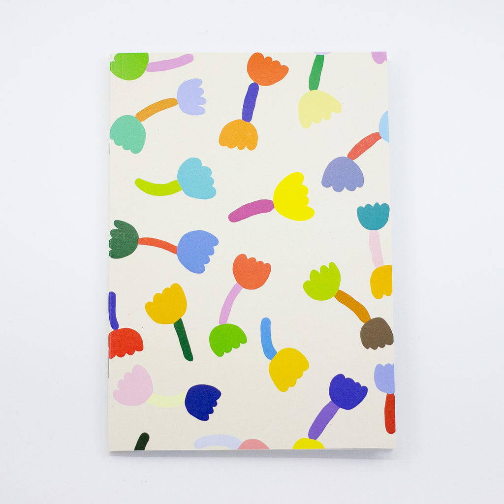 Front view of the tulip notebook. Cover has multicoloured tulip motif on cream background. 