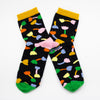 Side view of the shuh. Tulip socks. Pink heel, green toe, black background and muliticoloured tulip motifs. 
