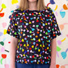 Another Front view of the Tulip Linen top, with black background. Multicoloured repeated tulip motifs. 