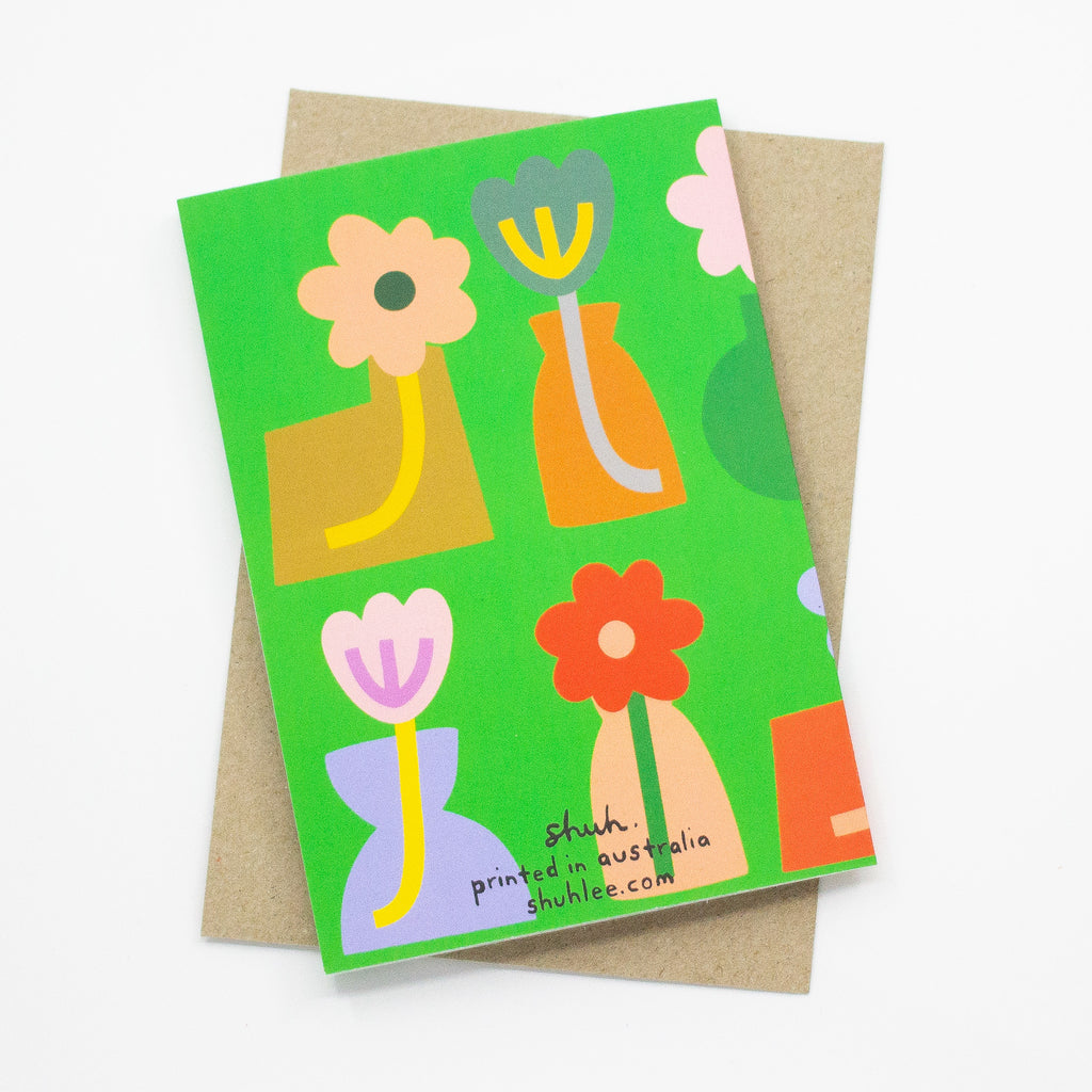 Back view of the vases print card. Tulip illustrations in bold vases of different shapes, over a green background.