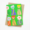 Front view of the vases print card. Tulip illustrations in bold vases of different shapes, over a green background.