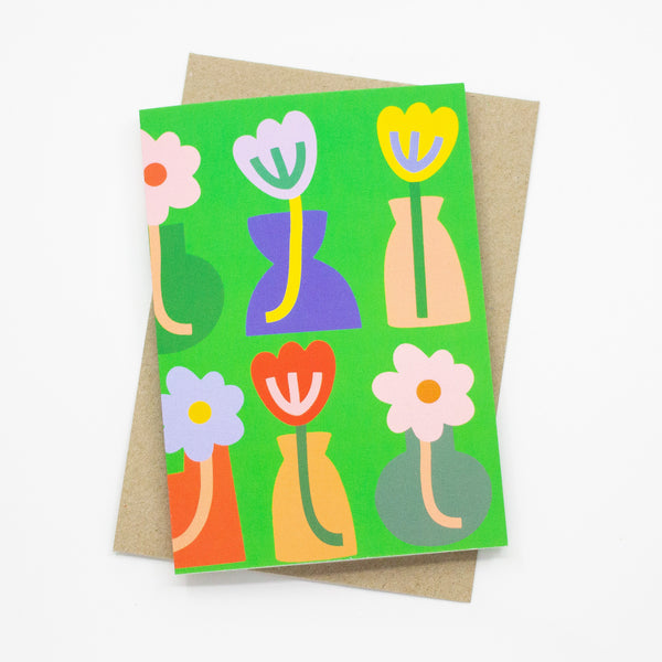 Front view of the vases print card. Tulip illustrations in bold vases of different shapes, over a green background.