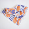 A textured cotton tea towel with a white base and a colourful waffle-knit pattern featuring vegetable print, shown on a clean white background.