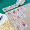 Mushroom-themed stamps on a cutting mat with a roll of tape and pen.
