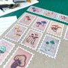 Collection of mushroom-themed stamps on a surface with a bottle of ink and paper in the background.