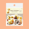 Stickers featuring animal shapes and patterns, each decorated with colourful breakfast foods like bread, bun and cake arranged on a solid peach background.