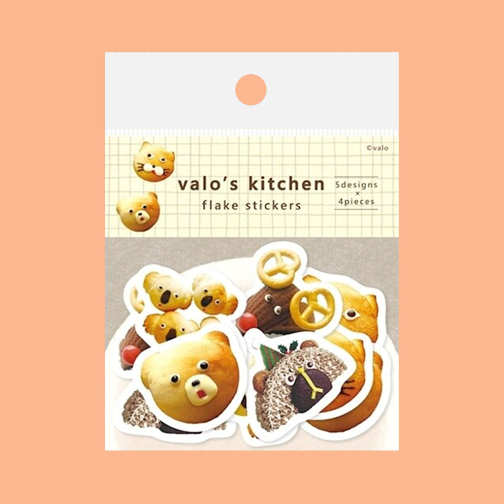 Stickers featuring animal shapes and patterns, each decorated with colourful breakfast foods like bread, bun and cake arranged on a solid peach background.