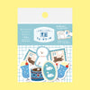 Sticker pack featuring cute winter-themed stickers including fluffy dog, swans, cats, and colourful cups, shown in its retail packaging against a pale yellow background.
