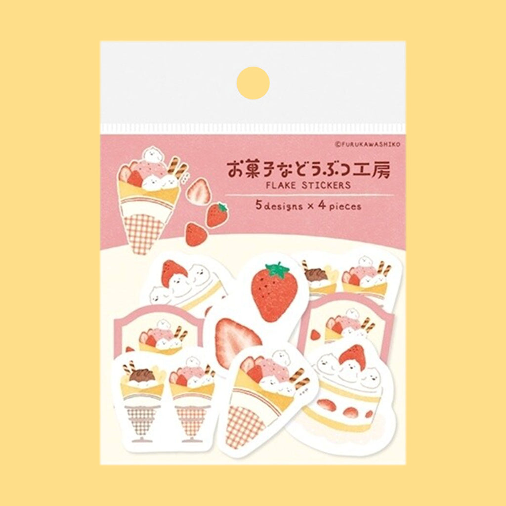 A package of Japanese-style flake stickers featuring strawberry ice cream and cake illustrations, displayed on a soft yellow background.