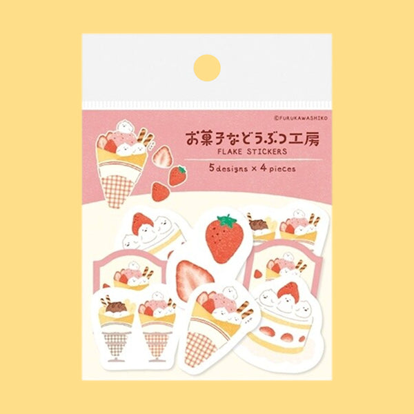 A package of Japanese-style flake stickers featuring strawberry ice cream and cake illustrations, displayed on a soft yellow background.