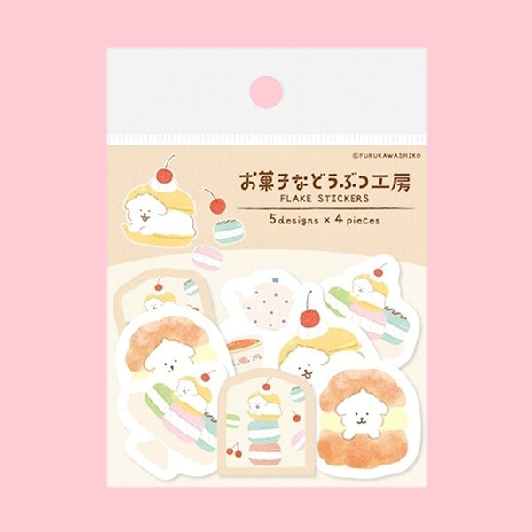 A package of cute Japanese sticker sheets featuring pastel macarons, cakes, and a small character on a cream card, set against a solid pink background.