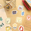 Collection of decorative stickers on a beige surface with a glass jar and paper.