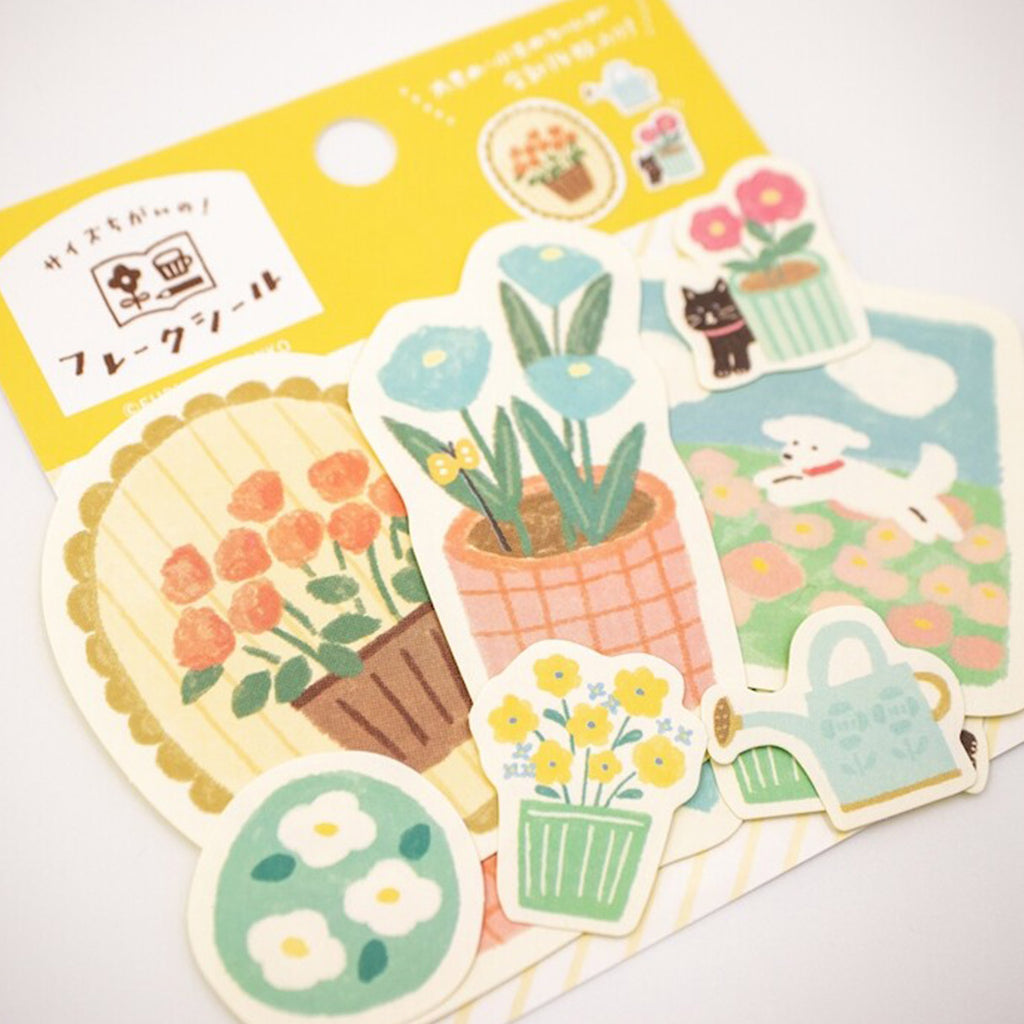 Set of decorative stickers with floral and gardening-themed designs on a yellow backing.