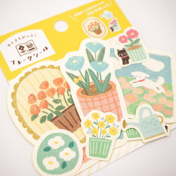 Set of decorative stickers with floral and gardening-themed designs on a yellow backing.