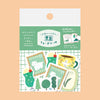 Sticker pack featuring cute green-themed stickers including a green stocking with a white dog, a yellow mug with a bird, and green trees, displayed on a peach-coloured background.