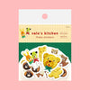 Stickers featuring whimsical shapes and patterns, each decorated with colourful sweet foods like cookies and chocolate, arranged on a solid pink background.