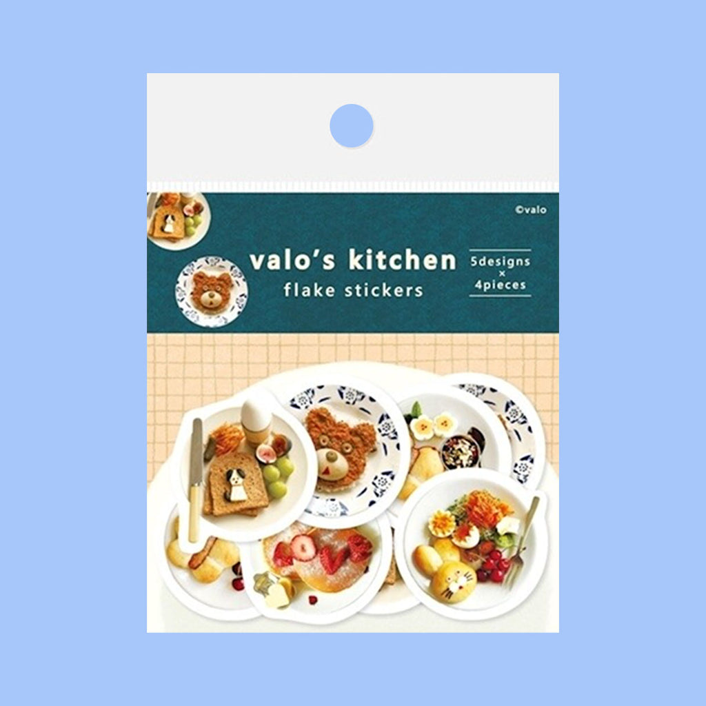 Stickers featuring white plates with whimsical shapes and patterns, each decorated with colourful breakfast foods like pancakes, fruit, and eggs, arranged on a solid blue background.