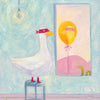 A whimsical painted scene showing a white goose wearing a red mask and red boots, standing on a stool in a room with a light blue wall and pink floor. A framed mirror or picture on the wall reflects a yellow bird shape with a pink landscape.
