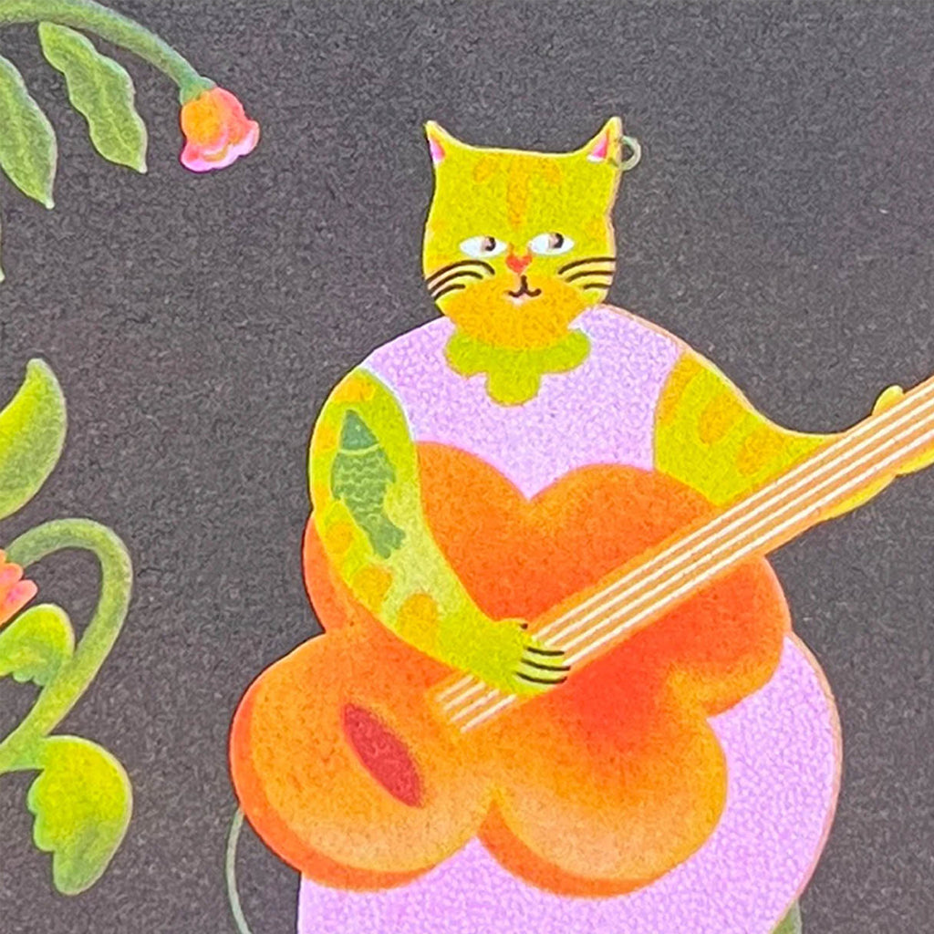 A stylised illustration of a yellow cat with a green collar playing an orange guitar against a dark charcoal background with floral details.