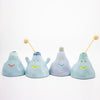 Set of four light blue ceramic vases with smiling faces on a white background
