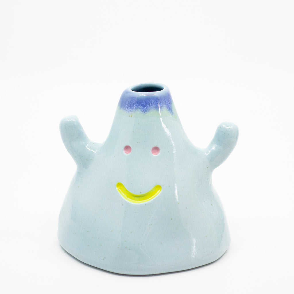 Ceramic vase shaped like a ghost with a smiling face on a white background