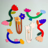 Colourful wooden floral shapes on a mint background