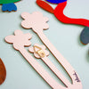 Colourful wooden floral shapes on a mint background