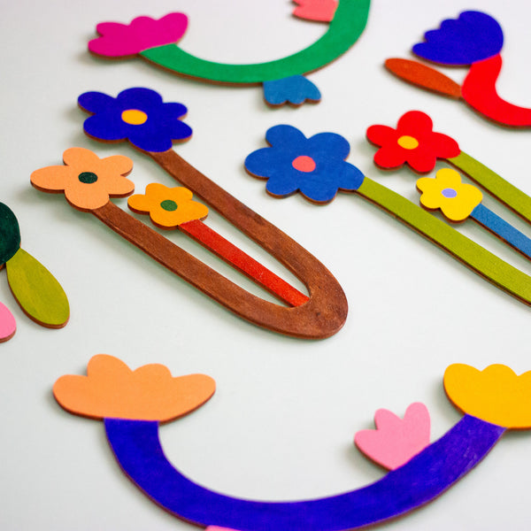 Colourful wooden floral shapes on a mint background