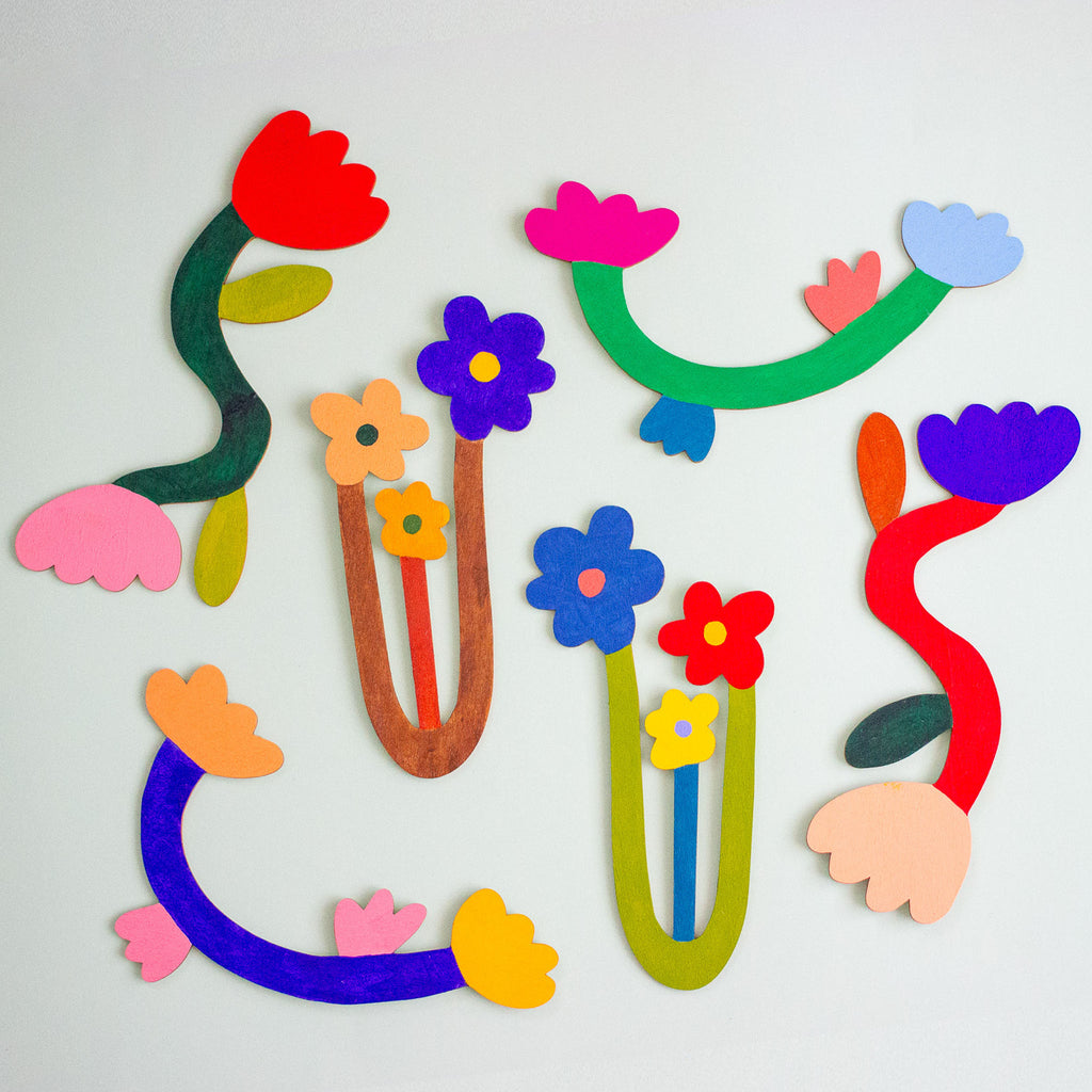 Colourful wooden floral shapes on a mint background