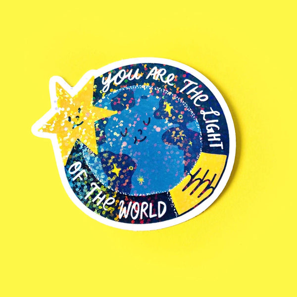 Illustration of a star and hands hugging the earth holographic sticker