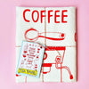 Tea towel with coffee-themed design on a pink background